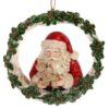Ornament Kerstman in kerstkrans met koek